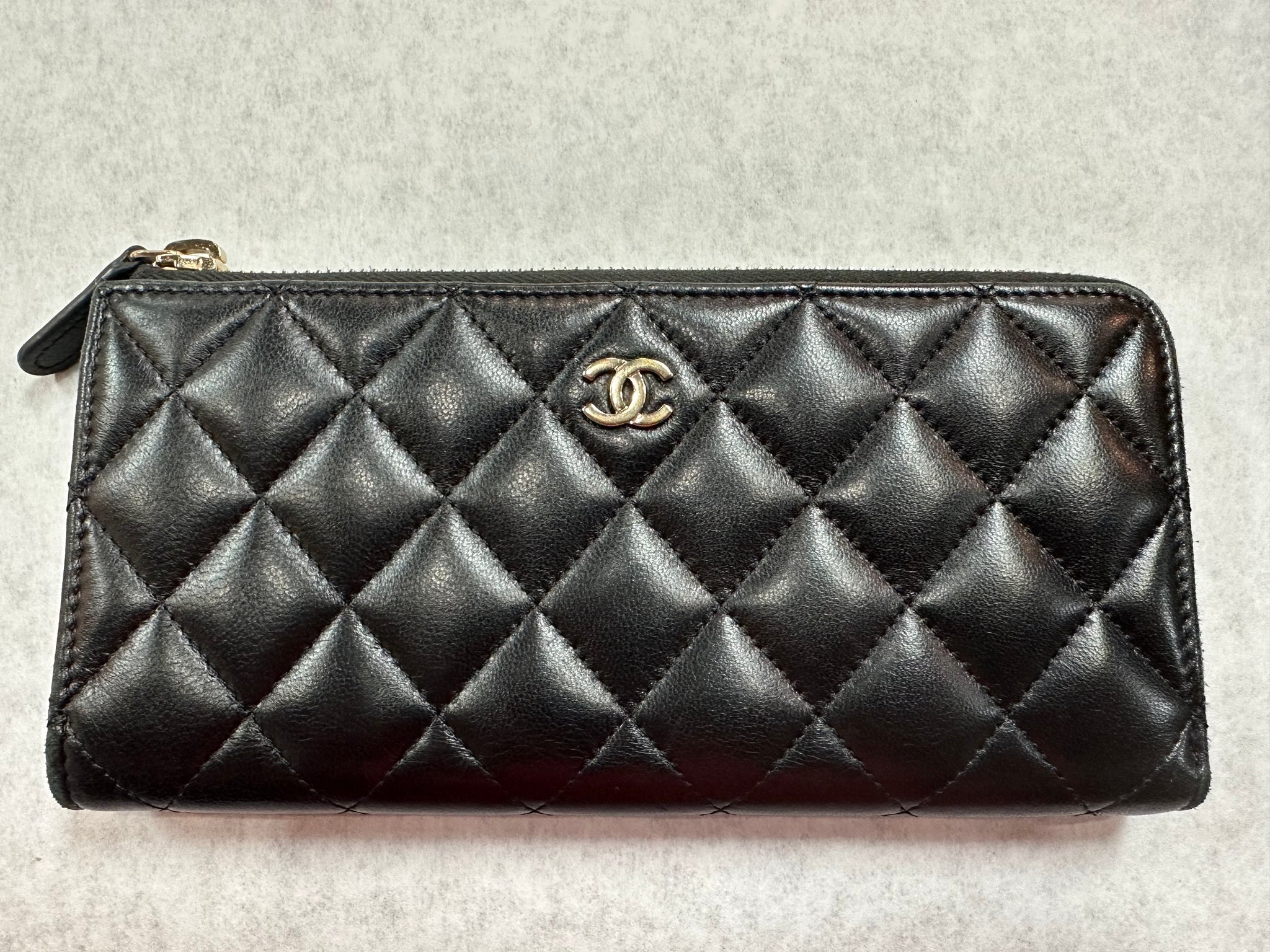 Authentic Chanel Black Lambskin Quilted Zipper Wallet – Relics to  Rhinestones