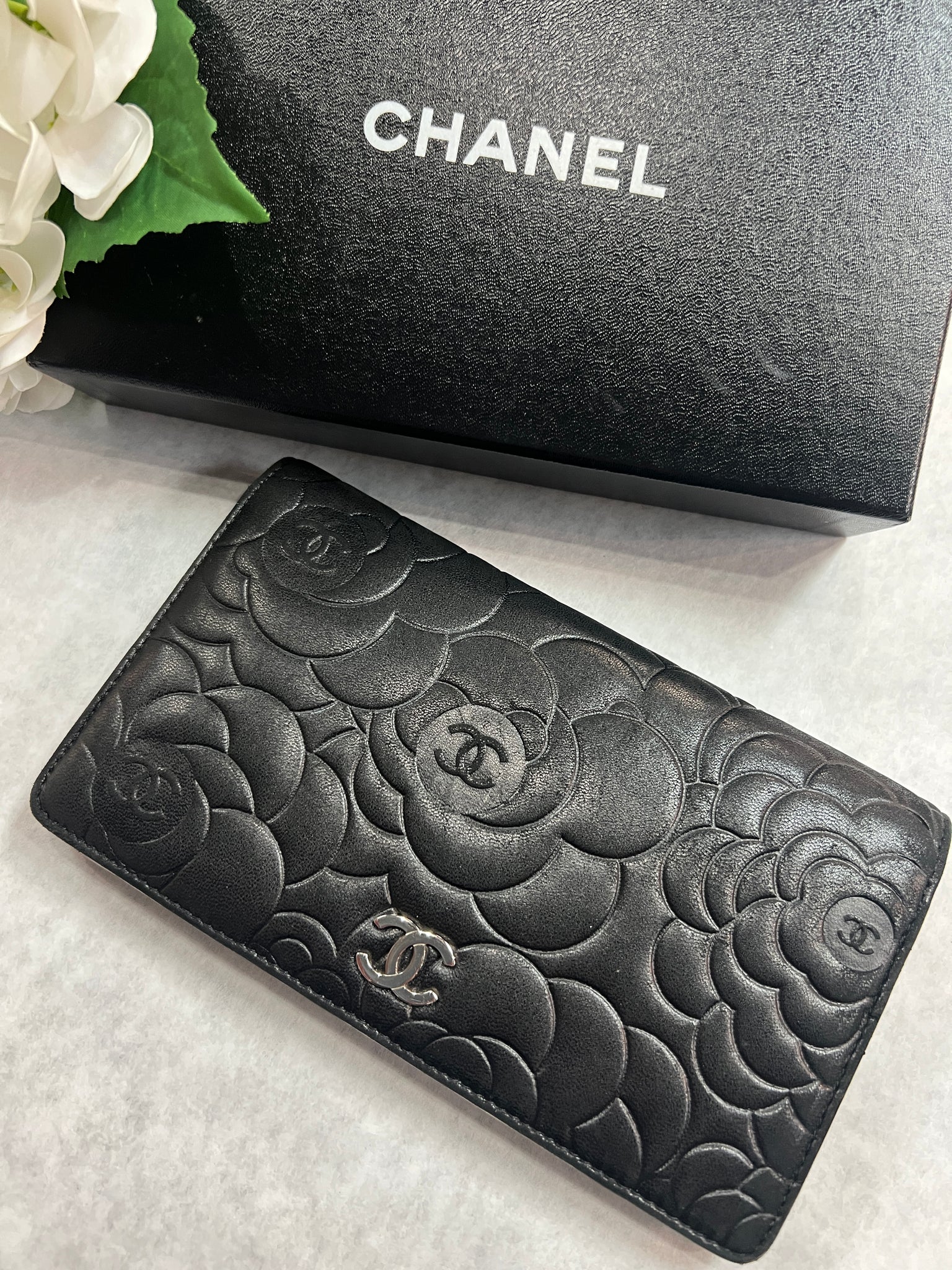 CHANEL Lambskin Camellia Embossed Yen Wallet Black 1171495